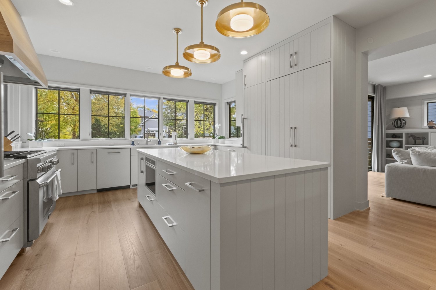 Wood flooring in a bright kitchen with a central island